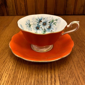 Royal Albert Marguerite, Bright Orange, Avon Shape Teacup and Saucer with Blue Marguerite Flowers