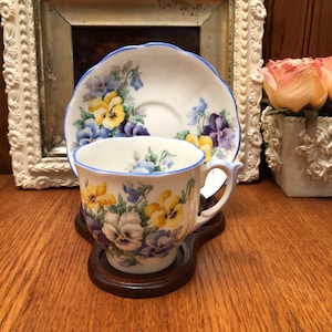 Taza de té vintage de porcelana fina con forma de campana y platillo con diseño de pensamientos y ribete azul