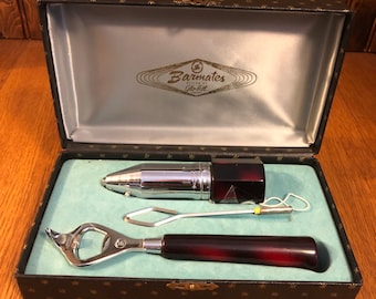 May include: A vintage Barmates cocktail set in a black box with a blue lining. The set includes a bottle opener, a cocktail stick, and a small bottle with a red cap.