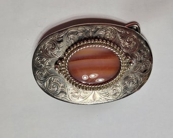 Cowboy belt buckle with red pearl center