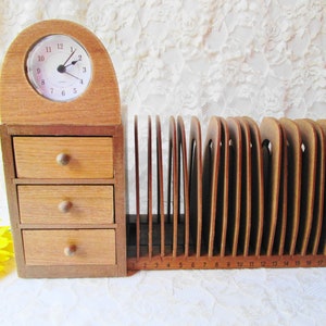 May include: Wooden desk organizer with three drawers and a clock on top. The organizer has a letter holder with 19 slots numbered 1 through 19.
