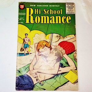 May include: A vintage comic book cover featuring a couple on a beach under an umbrella. The cover is titled "Hi-School Romance" and features the text "Now Published Monthly" and "Approved by the Comics Code Authority".