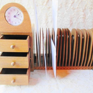 May include: Wooden desk organizer with three drawers and a clock on top. The organizer has a mail sorter with 18 slots numbered 1 through 18.