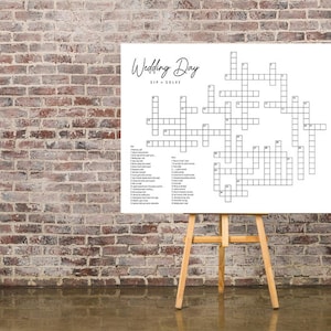 May include: A white crossword puzzle on an easel with the title "Wedding Day" and a list of clues on the side.