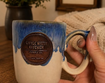 12oz handmade ceramic mug candle vessel containing a soy wax wooden wick marshmallow fluff scented candle in a one of a kind candle mug