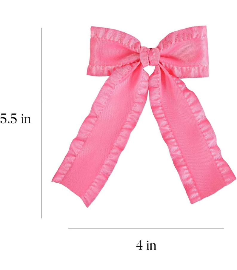May include: A pink satin bow with ruffled edges. The bow measures 5.5 inches in length and 4 inches in width.