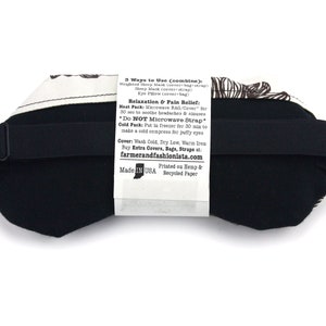 May include: Black sleep mask with a white and brown patterned cover. The mask has an adjustable strap and is made in the USA. The text on the back of the mask reads: "3 Ways to Use (combine): Weighted Sleep Mask (cover-bag-strap) Sleep Mask (cover-strap) Eye Pillow (cover+bag) Relaxation & Pain Relief: Heat Pack: Microwave BAG/Cover for 30 sec to soothe headaches & sinuses *Do NOT Microwave Strap Cold Pack: Put in freezer for 30 min to make a cold compress for puffy eyes Cover: Wash Cold, Dry Low, Warm iron Buy Extra Covers, Bags, Straps at: farmerandfashionista.com Made IN USA Printed on Hemp & Recycled Paper"