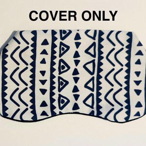 May include: A white sleep mask cover with a navy blue geometric pattern. The pattern includes triangles, chevrons, and zigzags. The mask is outlined in black, and the text "COVER ONLY" is at the top.