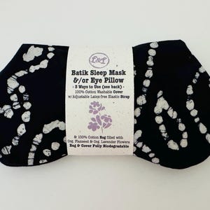 May include: Black batik sleep mask and eye pillow with white abstract patterns. The mask has an adjustable latex-free elastic strap and a 100% cotton washable cover. The product includes a cotton bag filled with organic flaxseed and lavender flowers.