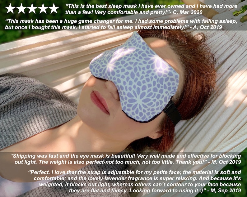 May include: A woman wearing a lavender eye mask with a floral pattern lies in a hammock. The eye mask has an adjustable strap and is weighted to block out light. The text "This is the best sleep mask I have ever owned and I have had more than a few! Very comfortable and pretty!" - C, Mar 2020 is visible in the image.
