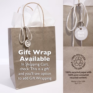 May include: A brown paper gift bag with white tissue paper inside. The bag has a white string handle and a small tag that says "Gift Wrap Available". The tag also includes instructions on how to add gift wrapping in the shopping cart. The bag is made from 100% recycled paper with 100% post-consumer recycled content.