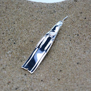 Freediving fin necklace, made from highly polished, tarnish resistant silver, strung on a strong cord. Fin used in apnea & spear fishing.