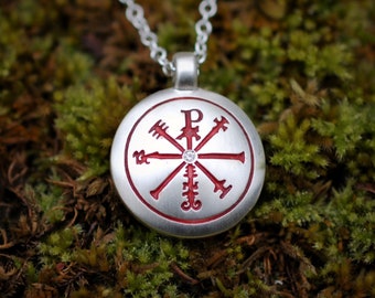 Diamond Canterbury Amulet for protection against evil with blood-red details and a satin finish on a silver chain. © Argent Aqua