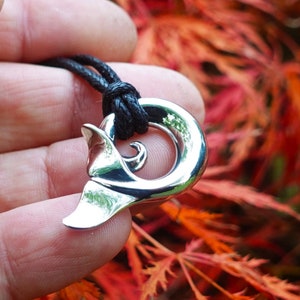 Whale spirit necklace, Made from highly polished, tarnish resistant silver, Whale tail koru design. © Argent Aqua