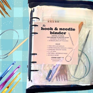May include: A clear vinyl binder with a black trim, containing knitting and crochet supplies. The binder includes a label that reads "the hook & needle binder" and lists features like pockets and pouches. Crochet hooks in various colors are visible.