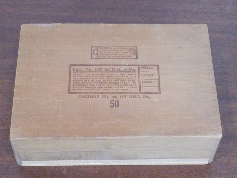 May include: A wooden box with a brown label that reads "Fact. No. 160 1st Dist. of Pa. FACTORY NO. 160 1ST DIST. PA. 50". The label also includes a table with the headings "PACKER", "HANDER", and "COLOR".