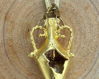 Gold plated Amphora pendant hangs on an antique gold chain. .