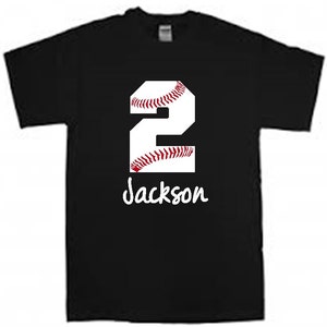 May include: Black t-shirt with a white baseball-themed number "2" and the name "Jackson" written below.