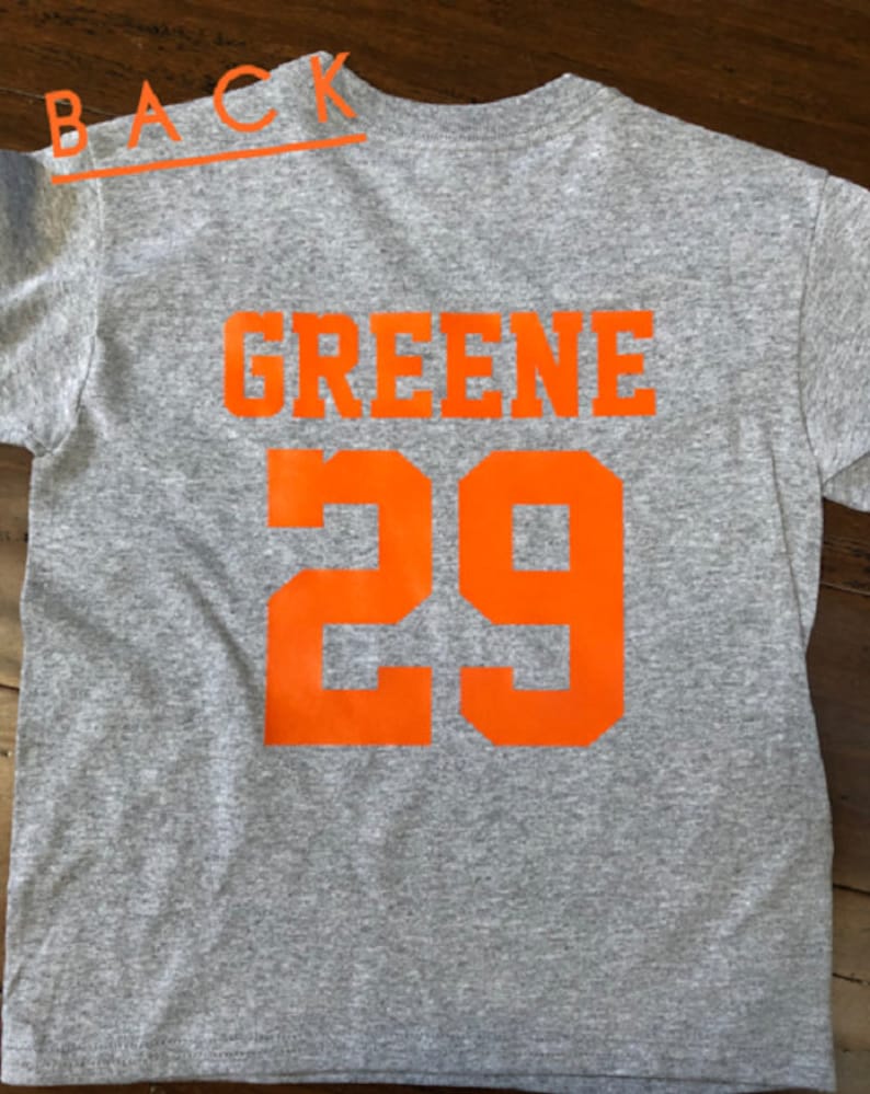 May include: Gray t-shirt with the name "GREENE" and the number "29" printed in orange on the back.
