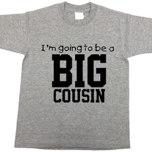 May include: Gray t-shirt with black text that reads "I'm going to be a BIG COUSIN".