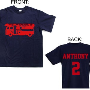 May include: A navy blue t-shirt with a red fire truck graphic on the front. The back of the shirt has the name "ANTHONY" and the number "2" in red.