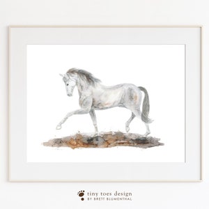 May include: A watercolor painting of a white horse with a brown mane and tail, running through a brown and gray muddy field. The horse is in mid-stride, with its legs extended. The painting is set against a white background.