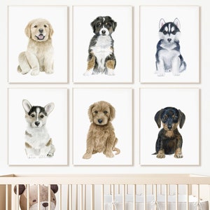 May include: Six watercolor paintings of different dog breeds, each framed in a white frame. The paintings are hung on a white wall above a white crib with a teddy bear inside.