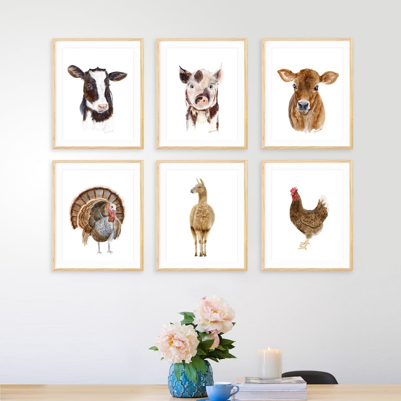 May include: Six framed watercolor paintings of farm animals, including a cow, pig, calf, turkey, llama, and chicken. The paintings are all in a white frame with a light wood finish.