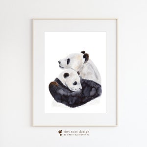 a picture of two panda bears in a frame