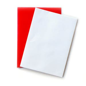 May include: A white sheet of paper is placed on top of a red sheet of paper. Both sheets are rectangular and have a smooth, flat surface.