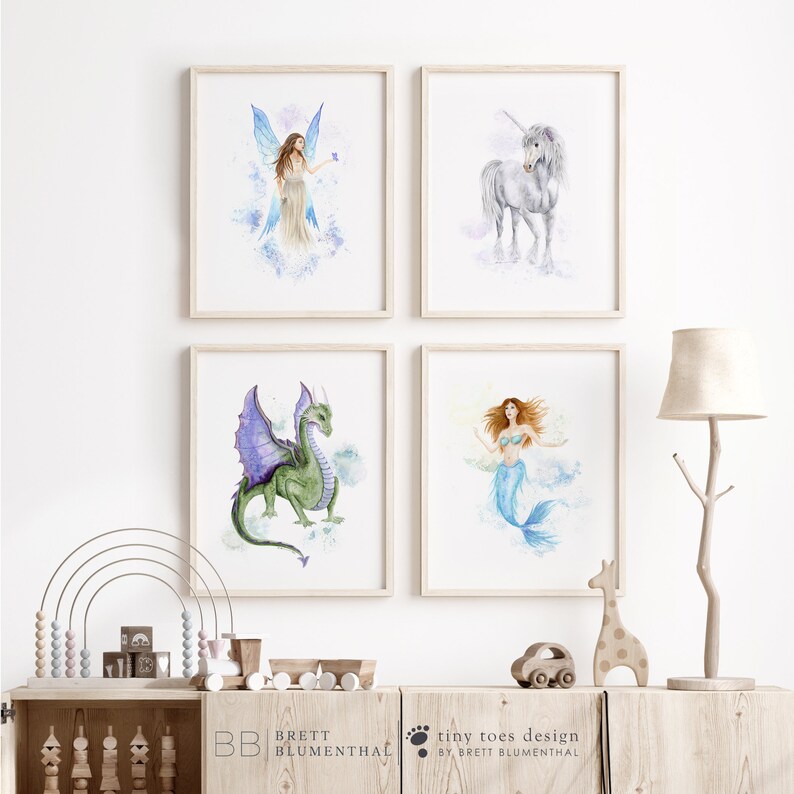 May include: Four framed watercolor illustrations of mythical creatures: a fairy, a unicorn, a dragon, and a mermaid. The illustrations are set against a white background and are framed in natural wood frames.