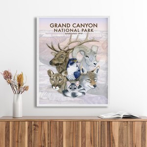 The image is a framed poster of various animals, including a deer, a bird, a wolf, and a cat, set against a landscape of mountains and a sunset.