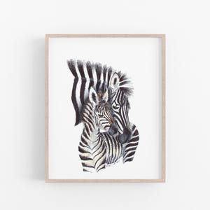 A framed print depicting two zebras, one adult and one foal, with their distinctive black and white striped patterns.