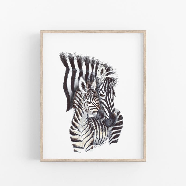 A framed print depicting two zebras, one adult and one foal, with their distinctive black and white striped patterns.