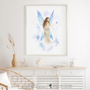 May include: A watercolor painting of a fairy with blue wings and a flowing white dress. The fairy is holding a small purple butterfly in her hand. The background is a light blue and purple watercolor wash.