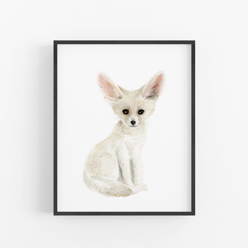 A framed print of a white fox sitting on its hind legs, with its large ears and pointed nose.