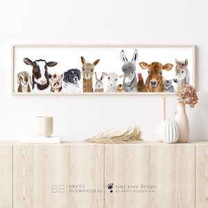 May include: A watercolor painting of a group of farm animals, including a cow, pig, dog, llama, rabbit, sheep, donkey, rooster, cat, and horse. The animals are all looking at the viewer with their heads tilted slightly. The painting is framed in a light wood frame.
