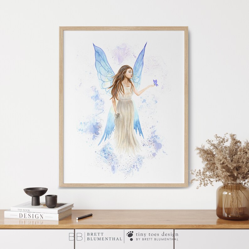May include: A watercolor painting of a fairy with blue wings and a flowing white dress. The fairy is holding a purple flower in her hand. The background is a light blue with white splatters.