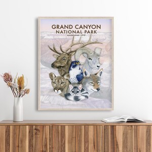 The image is a framed poster of various animals, including a deer, a bird, a wolf, and a cat, set against a landscape of mountains and a sky.
