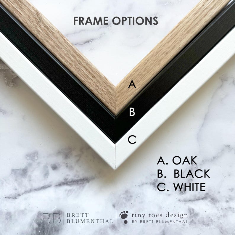 a variety of frame options, including A.OAK, B. BLACK, and C. WHITE, arranged in a triangular shape on a marble background.