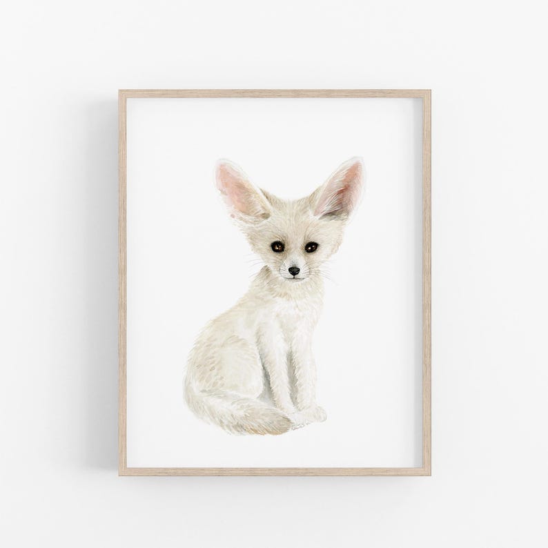 A framed print of a white fox sitting on its hind legs, with its large ears and pointed nose.