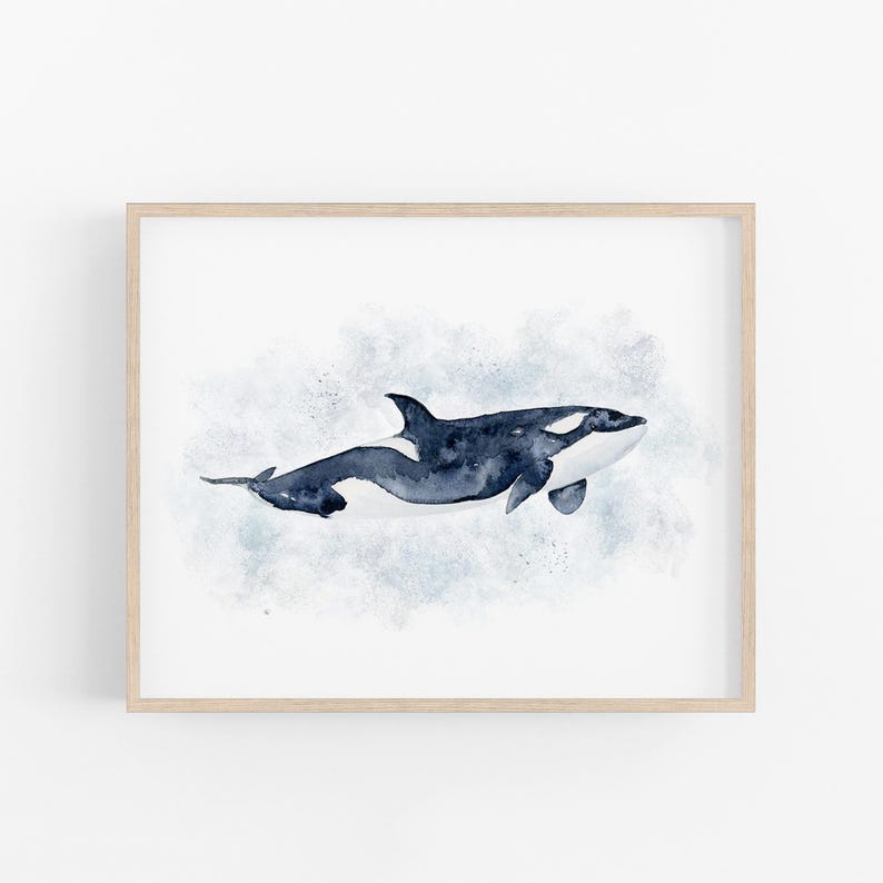 The image is a framed print depicting a watercolor painting of a whale swimming in the ocean.