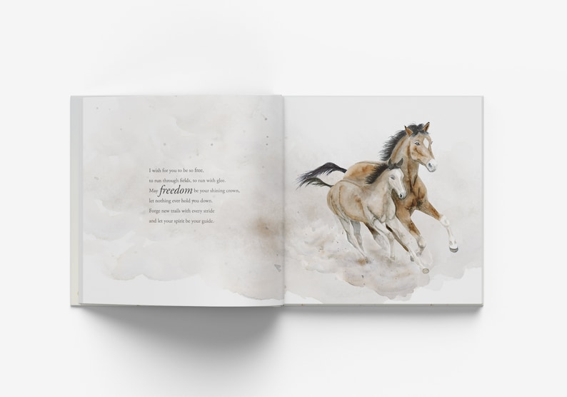 May include: A watercolor illustration of two horses running through a field. The horses are brown and white, and the background is a soft, watercolor wash of gray and white. The text "I wish for you to be so free, to run through fields, so vast with glee, may freedom be your driving crown, let nothing ever hold you down. Forge new trails with every stride and let your spirit be your guide." is written in black ink on the left page.