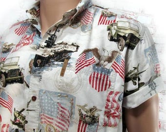 May include: A white short-sleeved button-up shirt with a patriotic print featuring American flags, eagles, military vehicles, and airplanes.