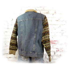 May include: A blue denim jacket with a brown corduroy collar and brown, green, and orange patterned knit sleeves.