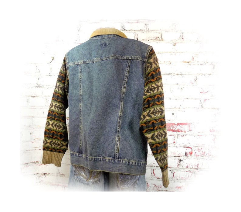 May include: A blue denim jacket with a brown corduroy collar and brown, green, and orange patterned knit sleeves.