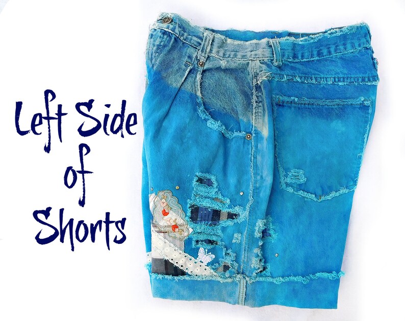 May include: The left side of a pair of blue denim shorts with distressed details, patches, and a white lace trim. The shorts are a light blue color and have been heavily distressed with rips and tears.
