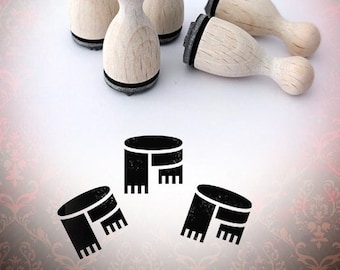 May include: Four wooden stamps with black ink pads, shaped like a rounded rectangle, with a design of a scarf. The stamps are arranged on a white surface. The word "Bloody Nose" is written in a stylized font in the upper right corner of the image.