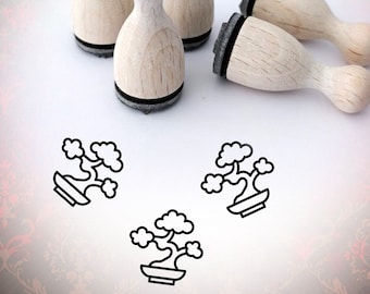 May include: Set of five wooden stamps with black ink pads. Each stamp features a simple line drawing of a bonsai tree.