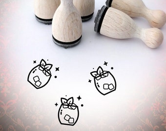 May include: Four wooden rubber stamps with black ink pads. Each stamp features a line drawing of a cocktail with ice cubes and a sprig of mint. The stamps are arranged on a white surface. The text "Bloody Nose" is visible in the background.